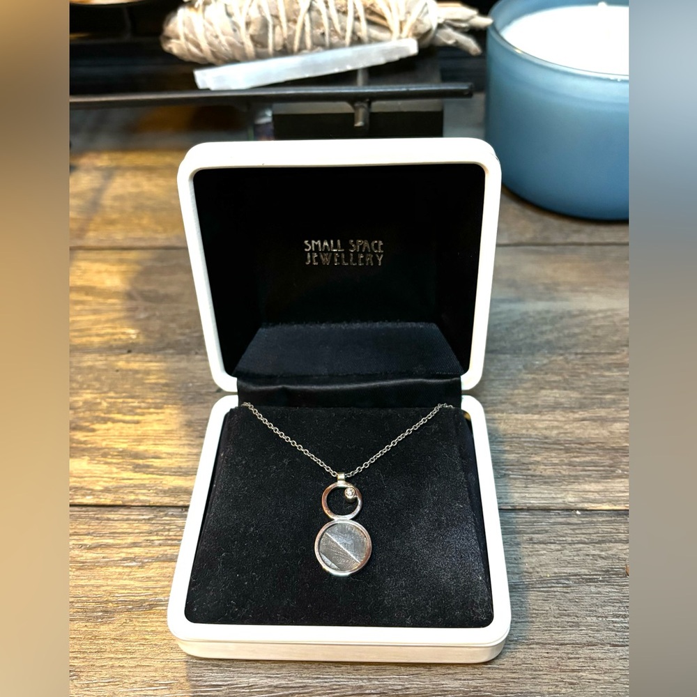 Double circle pendant with 9 carat
diamond and meteorite